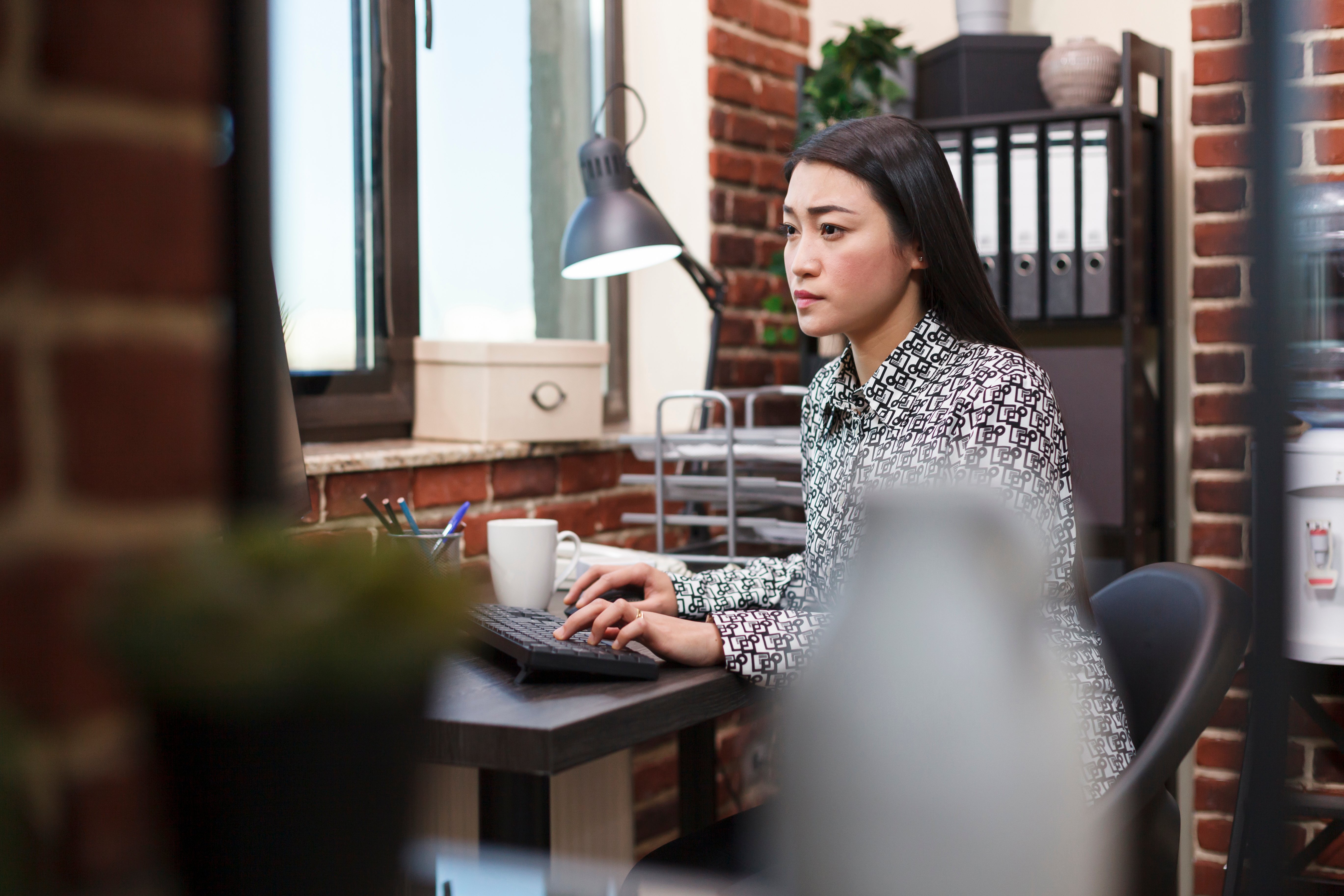 Woman sitting on a chair typing on a keyboard